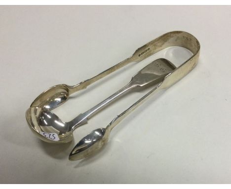EXETER: A small silver cream ladle together with a pair of tongs. Various dates and makers. Approx. 63 grams. Est. £20 - £30.