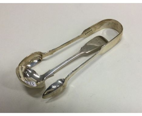 EXETER: A small silver cream ladle together with a pair of tongs. Various dates and makers. Approx. 63 grams. Est. £20 - £30.