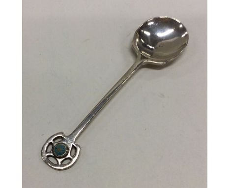 A E JONES: A silver and enamel spoon. Birmingham 1908. Approx. 22 grams. Est. £60 - £80.