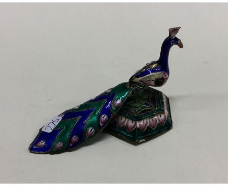 A silver and enamel figure of a peacock. Approx. 49 grams. Est. £50 - £80.