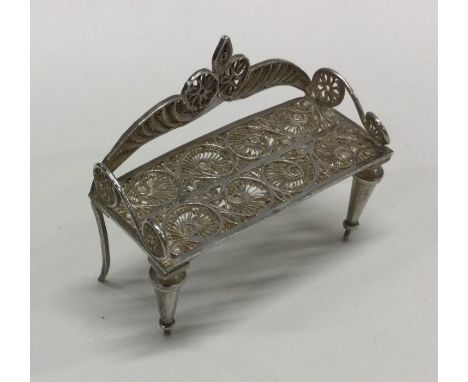 A large miniature Continental filigree silver bench. Approx. 26 grams. Est. £30 - £50.