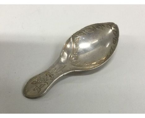 A silver caddy spoon with floral chased handle. London 1819. By James Beebe. Approx. 6 grams. Est. £60 - £80.