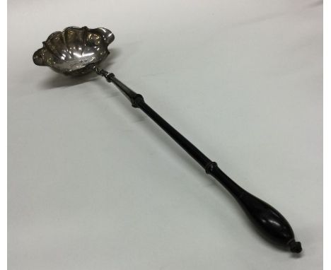 A large Antique silver toddy ladle with turned handle. London. By TA. Approx. 63 grams. Est. £70 - £80.