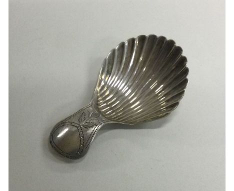 A silver engraved caddy spoon with floral decoration. Birmingham 1803. Approx. 4 grams. Est. £60 - £80.