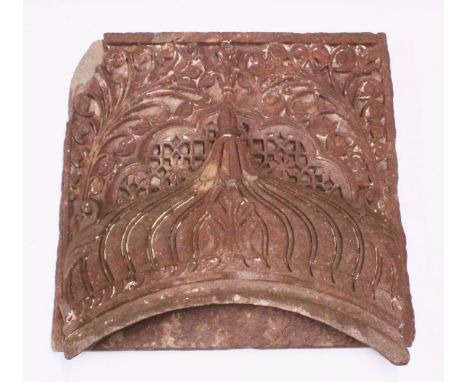 A LARGE AND VERY HEAVY INDIAN MUGHAL CARVED SANDSTONE PANEL, depicting and arch and flora, 67cm.