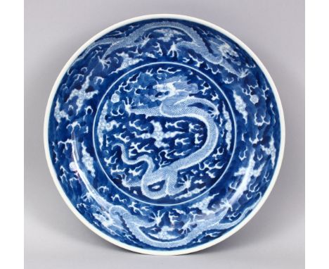 A GOOD CHINESE BLUE &amp; WHITE PORCELAIN MULTI DRAGON PLATE, decorated with an array of dragons amongst clouds, the base wit