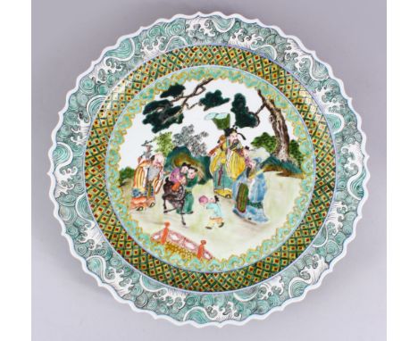 A LARGE CHINESE REPUBLIC STYLE FAMILLE ROSE SERPENTINE EDGE PORCELAIN CHARGER, the charger decorated with figures in a landsc