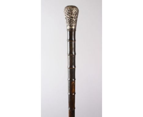 AN UNUSUAL 19TH CENTURY INDIAN SECTIONAL RHINO HORN WALKING STICK, WITH SILVER TOP, 85cm.