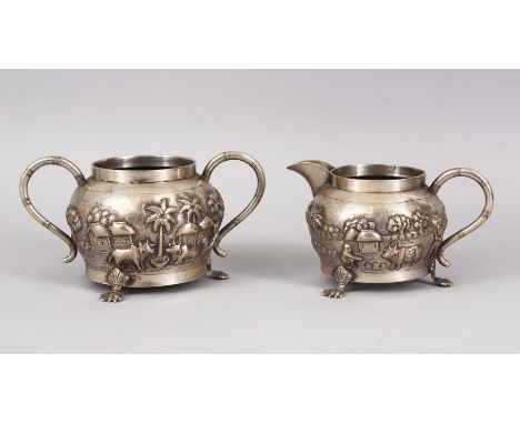 TWO 19TH CENTURY INDIAN CALCUTTA SILVER TEA SET ITEMS, sugar bowl and cream jug, with embossed decoration of figures in lands