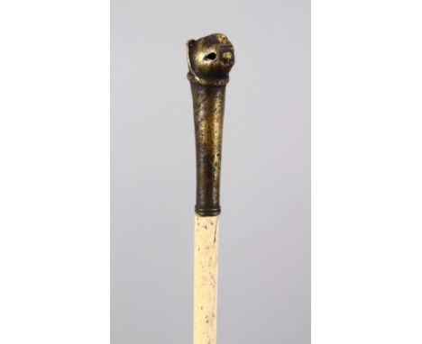 A 19TH CENTURY INDIAN MUGHAL TIGER HEAD MOUNTED WHALE BONE SWAGGER STICK, 82cm.