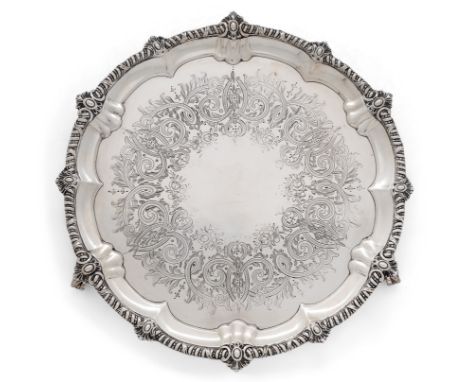 A Victorian silver salver. H. J. Lias & Son, London, 1868. Of shaped, circular form, the gadrooned border decorated with foli