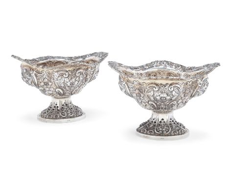 A pair of pierced Victorian silver baskets. Charles Stuart Harris, London, 1893. The shaped, quatrefoil bodies raised on pier