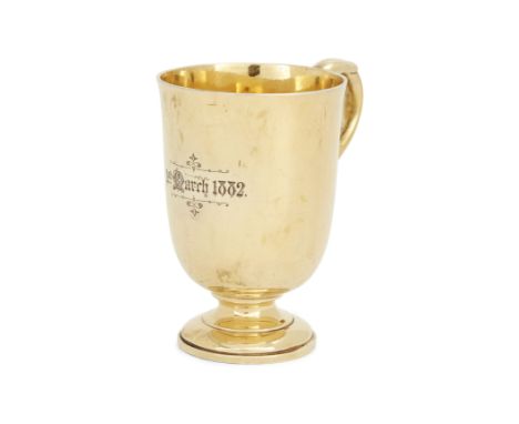 A Victorian silver gilt mug.R. & S. Garrard & Co.,London, 1874. Raised on a circular foot, the rounded body to a scroll handl