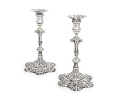 A pair of George II silver candlesticks. John Quantock,London, 1756. The cast candlesticks designed with hexafoil bases to ba