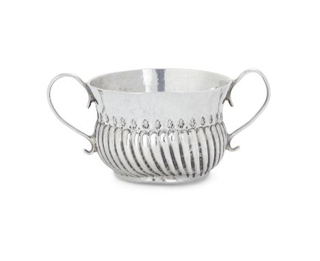 A Queen Anne miniature silver porringer. John Cowsey,  London, 1704. The twin-handled Britannia silver porringer designed wit
