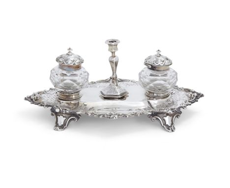 A Victorian silver inkstand.Henry Wilkinson & Co.,London, 1866-1867. The pierced base raised on four bracket feet and decorat