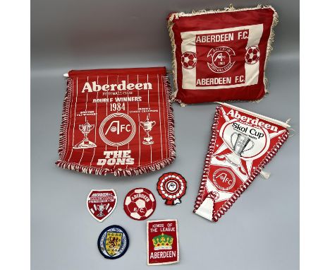 A collection of vintage Aberdeen football collectors items, cushion, flag, badges, pennants       