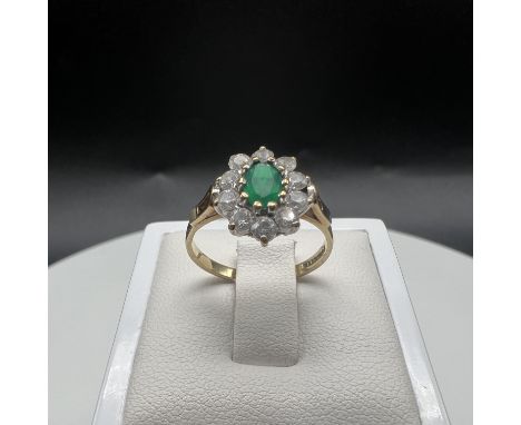 A 9ct yellow gold dress ring,
set with a cz green stone,
size K,
2 grams in weight