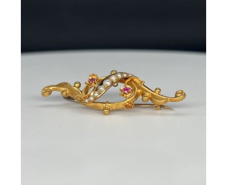 A 15ct yellow gold Victorian ruby and seed pearl brooch, 44mm x 17mm, weight is 2.9 grams
