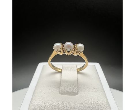 An 18ct yellow gold 3 stone cultured pearl ring,
size N,
weight is 2.5 grams