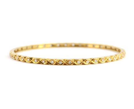 A yellow metal (tested high carat gold) diamond set bangle, Dia. 6.5cm. Approx. 12.3gr.&nbsp;