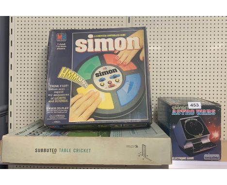 A boxed Subbuteo table cricket, a Simon computer game and an Astro Wars game.