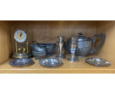 A quantity of silver plated items with a torsion mantle clock.