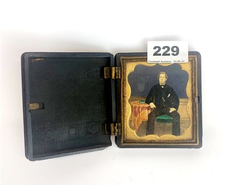 A 19th century vulcanite cased hand painted photograph portrait of a young man (A/F), 8.5 x 9.5 x 2cm.