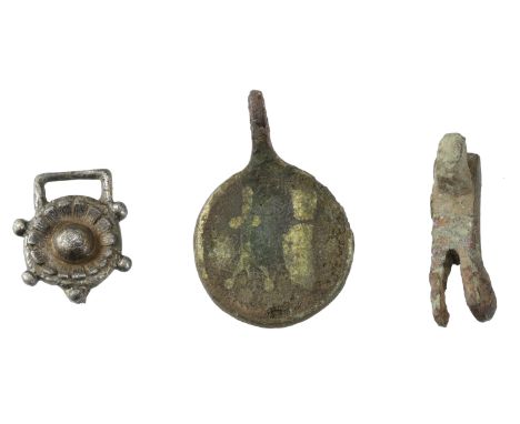 14th century, a circular gilt brass enamelled pendant, 23mm in diameter, decorated with a candlestick and a knife (?), suspen