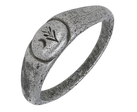 Roman, 3rd century, a silver ring, with oval hoop and sloping shoulders, bezel is raised and oval shaped, engraved with a bra