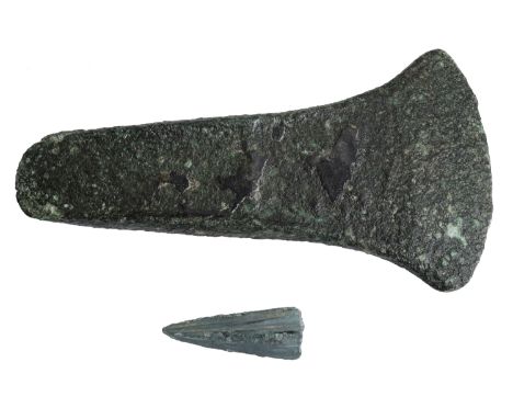Bronze Age, c. 1800-1500 BC, a flat axe with side flanges, 13 cm long by 6.7 cm wide by 1.4 cm deep; expanded curved cutting 