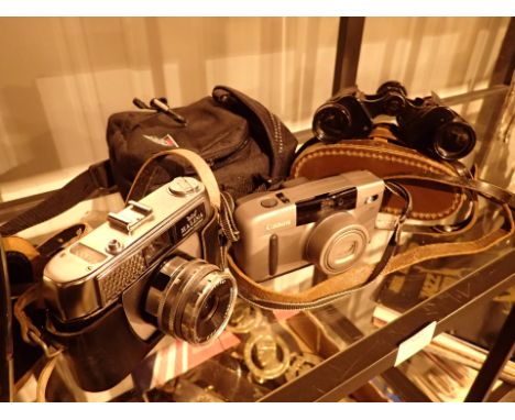 8 x 25 Delacroix binoculars Canon Z13 camera and a Halina example 