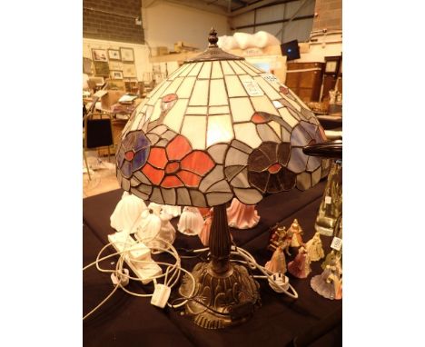 Large Tiffany style table lamp with glass shade and decorative cast base H: 60 cm  CONDITION REPORT: All electrical items in 