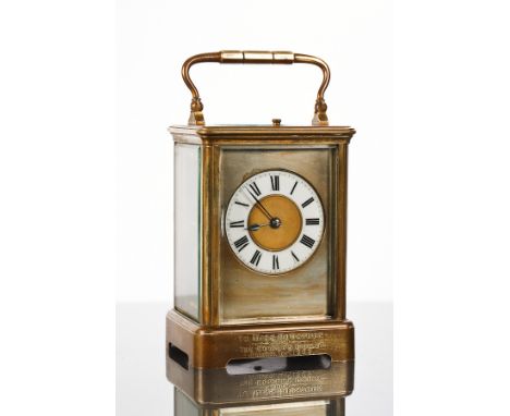 EARLY 20TH-CENTURY FRENCH BRASS REPEATING CARRIAGE CLOCK
the enamel chapter dial with Roman numerals, with presentation inscr