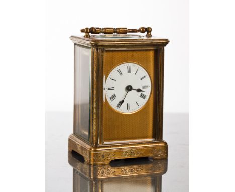 LATE 19TH-CENTURY BRASS CARRIAGE TIMEPIECE
the dial with Roman numerals, the brass case engraved with stylised foliate decora