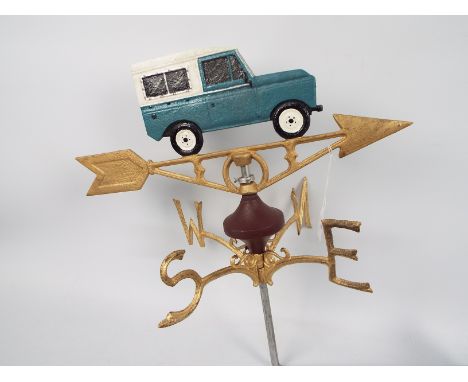 A cast iron, wall mountable, weather vane with Land Rover surmount, approximately 50 cm (h), appears in good condition (this 