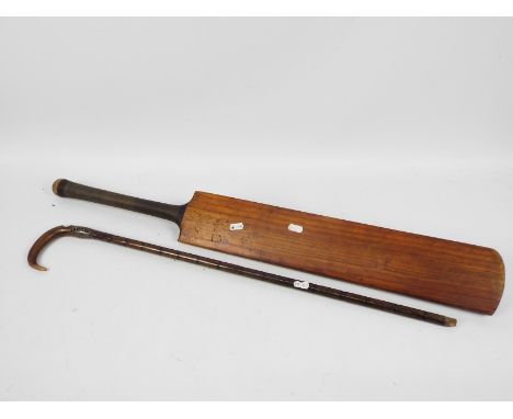 A vintage Shaw and Shrewsbury cricket bat, The George Gunn and a silver mounted, horn handled, walking stick.