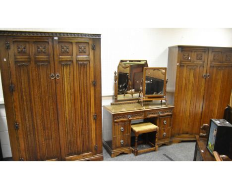 A Herbert Gibbs oak four shelf open book case; an oak linenfold three piece bedroom suite, comprising of a dressing table and