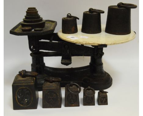 A set of of black painted cast iron balance scales and weights, 4lb - 4ox;  others stacking weights 