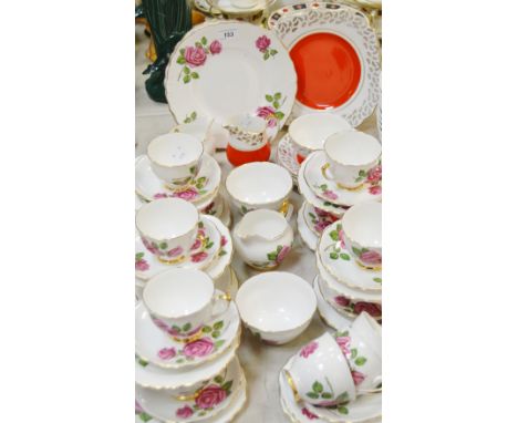 A Crown Regent English Rose tea service, comprising twelve teacups, eleven saucers, twelve tea plates, two sugar basins, two 