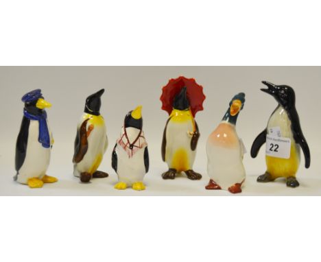 A Wade Penguin salt and pepper pot; a Beswick Penguin with a red umbrella, another with a walking cane; a West German ceramic