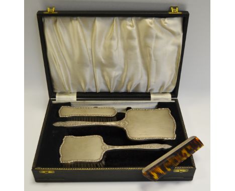 A silver four piece dressing table set, cased, Sheffield 1959