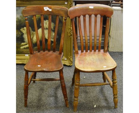 A pair of stained beech stick back kitchen chairs