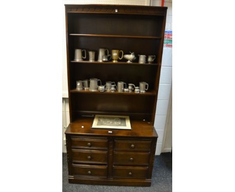 A dark Ercol dresser , four open shelves, projecting base , above six short drawers, turned handles