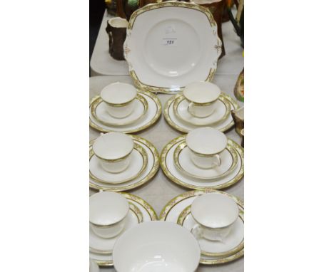 A Paragon star china six setting tea service decorated with flowers, pink flowers, within a yellow and gilt ground, printed m