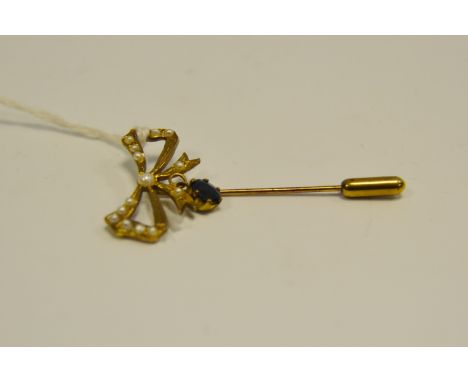 A 9ct gold stick pin, seed pearl ribbon with sapphire pendant