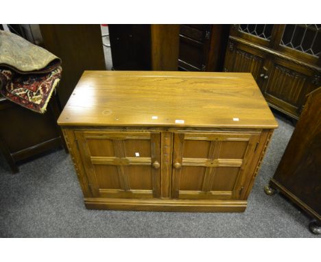 An Ercol light oak dresser base