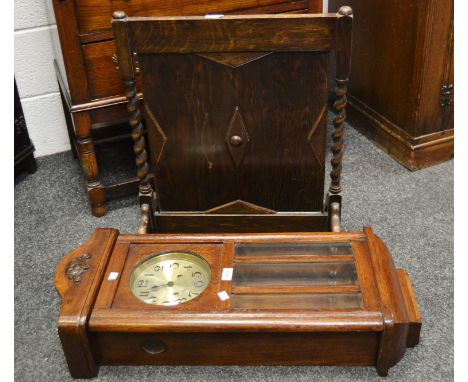 An early 20th Century oak firescreen, barley twist supports; an early 20th Century wall hanging clock c 1940 (2)