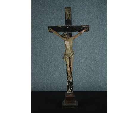 A 19th century carved Crucifix with 'INRI' painted on the top. The wood and plaster. The figure is quite fragile and is in ne