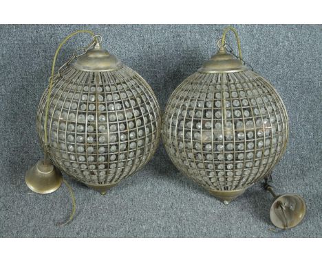 A pair of spherical beaded crystal glass and metal pendant light fittings. H.70cm. 